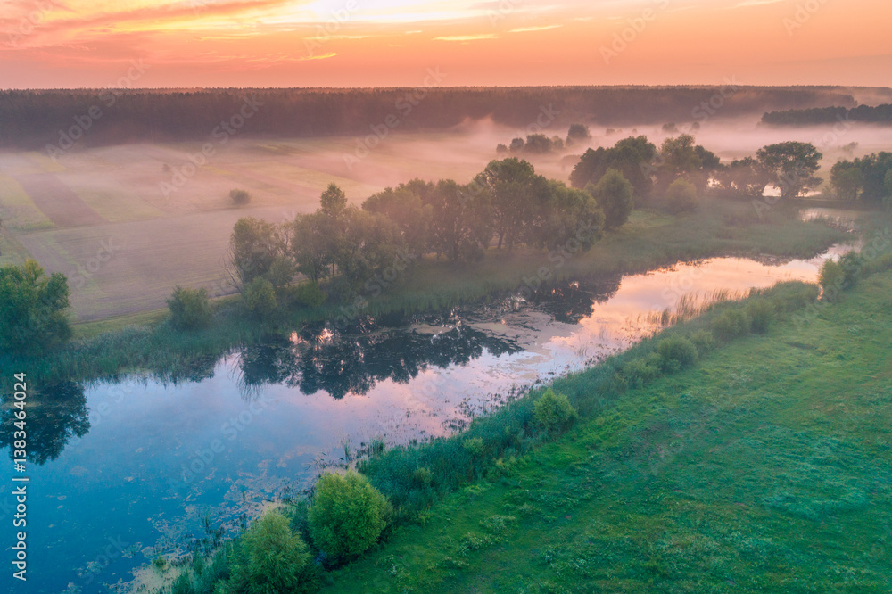 Magic sunrise over the lake. Misty early morning, rural landscape, wilderness, mystical feeling. Serenity lake in magical light