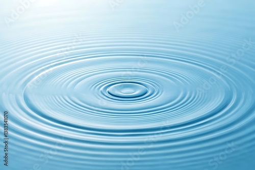 Tranquil ripples spreading outward from a single drop of water on a serene, pale blue surface.