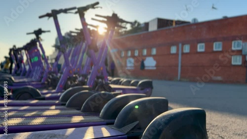 Electric scooters are parked in the city center. Modern public mobile transport