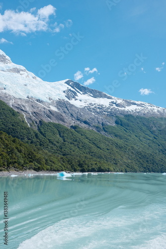 Wallpaper Mural Scenic view of catamaran Glacier tour in El Calafate, Patagonia — icy blue textures, turquoise lake waters, icebergs, jagged ice walls, cold weather, snowcapped ice peaks under a dramatic cloudy sky. Torontodigital.ca