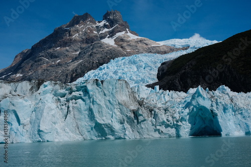 Wallpaper Mural An up-close look at jagged blue ice peaks of a Patagonian glacier, showcasing stunning details of the frozen formations with a mountain in the background. Taken in El Calafate, Argentina Torontodigital.ca
