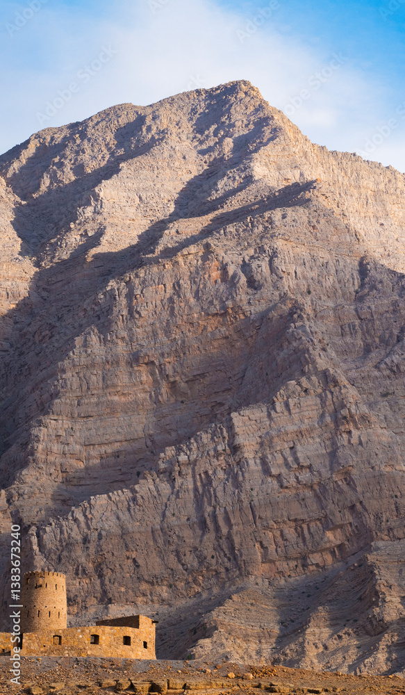 Oman, 03-04-2025: the Al Qala Fort against the mountain in Bukha, a fishing village in the Musandam Peninsula (Ruus Al Jibal), the northeastern point of Arabian Peninsula south of the Strait of Hormuz