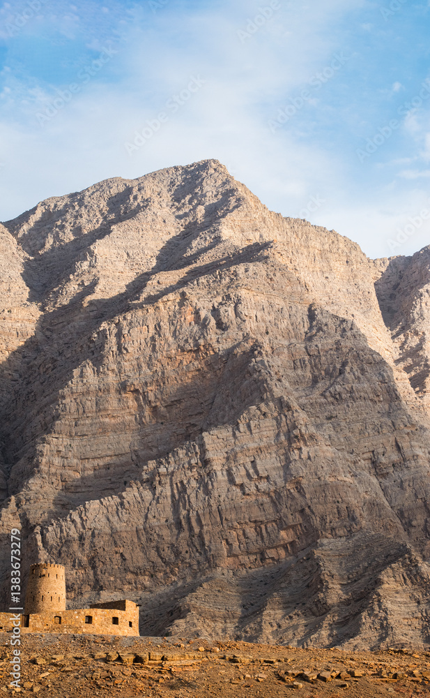 Oman, 03-04-2025: the Al Qala Fort against the mountain in Bukha, a fishing village in the Musandam Peninsula (Ruus Al Jibal), the northeastern point of Arabian Peninsula south of the Strait of Hormuz