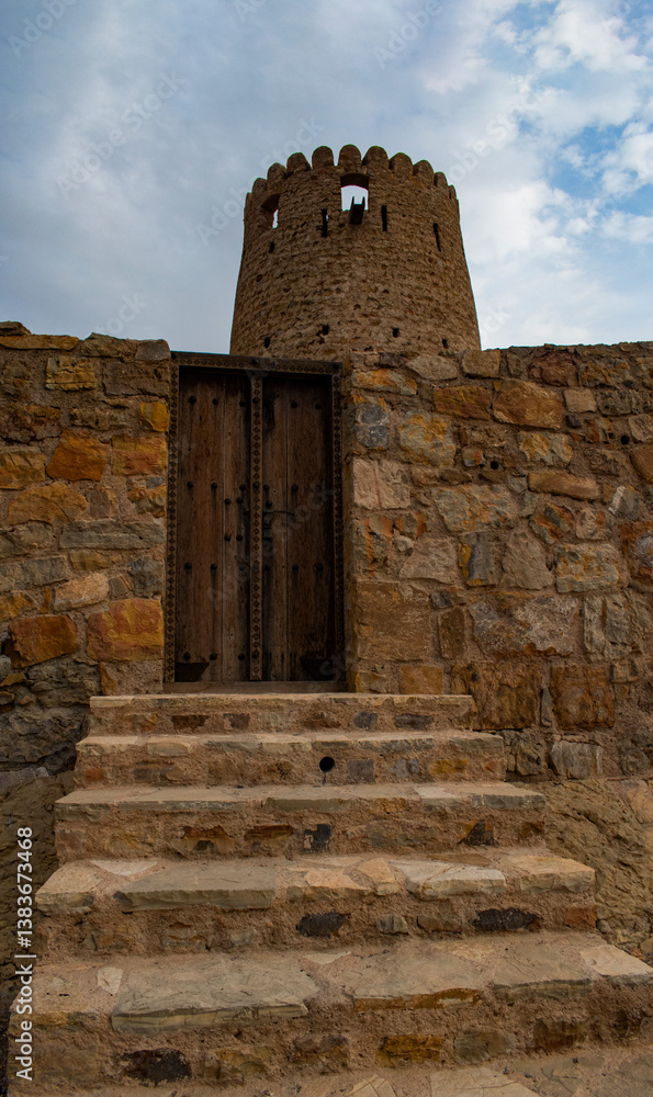 Oman, 03-04-2025: stairs and wooden door of the Al Qala Fort in Bukha, fishing village in Musandam Peninsula (Ruus Al Jibal), the northeastern point of Arabian Peninsula south of the Strait of Hormuz