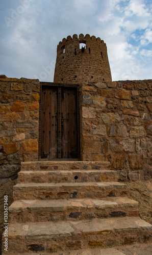 Obraz na płótnie Oman, 03-04-2025: stairs and wooden door of the Al Qala Fort in Bukha, fishing village in Musandam Peninsula (Ruus Al Jibal), the northeastern point of Arabian Peninsula south of the Strait of Hormuz w salonie