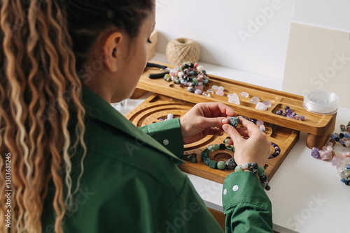Wallpaper Mural Woman crafting handmade gemstone bracelets at home. Artisan creating crystal healing bracelets. Natural stone. Crafting spiritual jewelry.   Torontodigital.ca