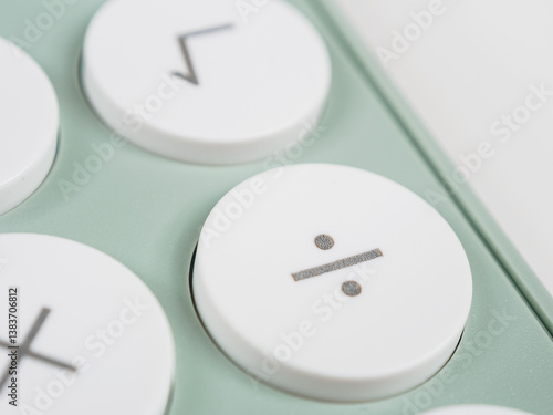 Photos division symbol key on a calculator, performing division operations