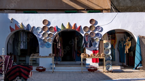 Stall in the market selling colorful plates and ceramics, in Douz, Tunisia
