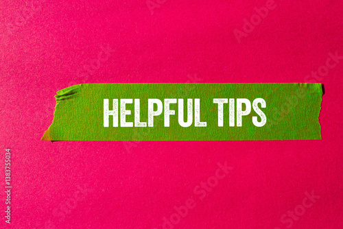 Cuadro en lienzo Helpful tips message written on ripped torn green paper tape on pink background