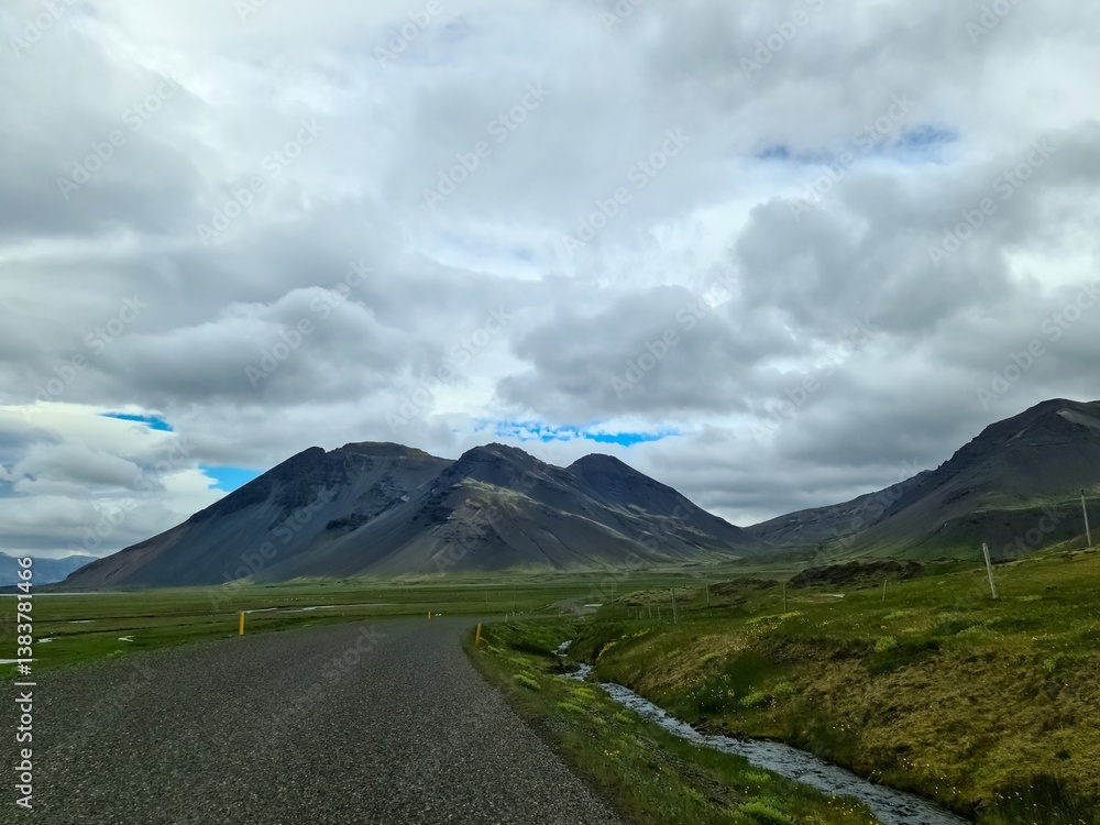 Fototapeta premium Scenic road winding through Iceland's majestic mountains and vast plains