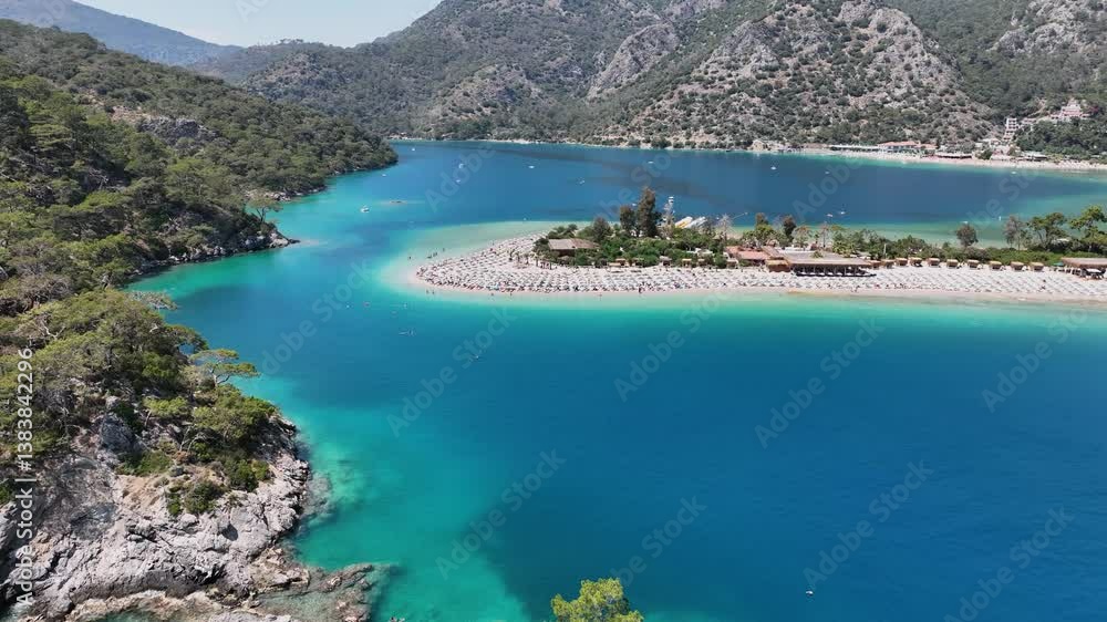 Aerial view of Oludeniz Beach with greenery, boats, turquoise ocean and green mountains Aerial view of Oludeniz Beach with greenery, boats, turquoise ocean and green mountains
