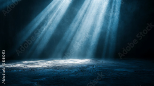 Brilliant rays of light illuminating a dusty concrete floor in a dark room, mystery and exploration concept