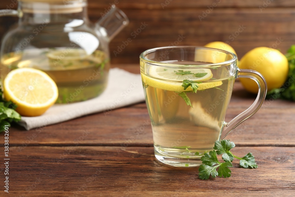 Healthy parsley tea with lemon slices on wooden table. Detox drink