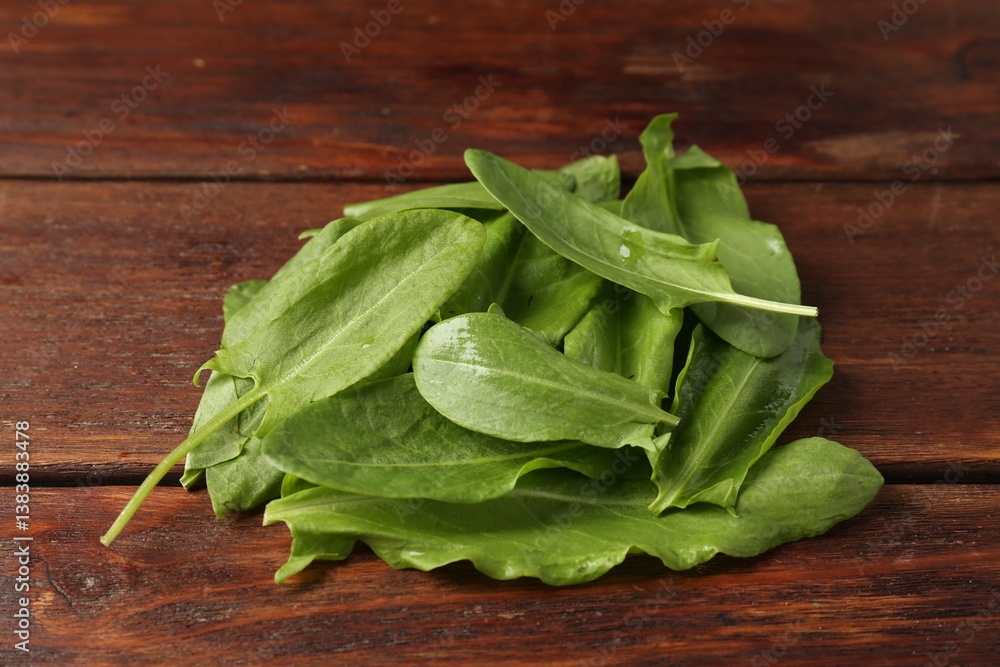 Pile of fresh green sorrel leaves on wooden table, closeup