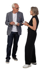 Two older grey-haired people standing and drinking coffee during a conference break. Isolated on transparent background