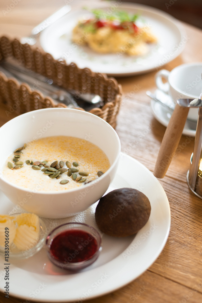 Breakfast at cafe with corn porridge and scrambled eggs Breakfast at cafe with corn porridge and scrambled eggs