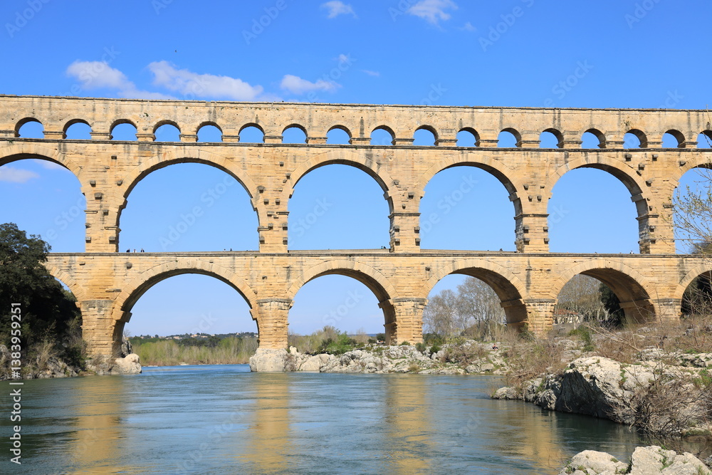 Pont du Gard, an ancient Roman aqueduct bridge crossing the Gardon River in Gard department, southern France Pont du Gard, an ancient Roman aqueduct bridge crossing the Gardon River in Gard department, southern France