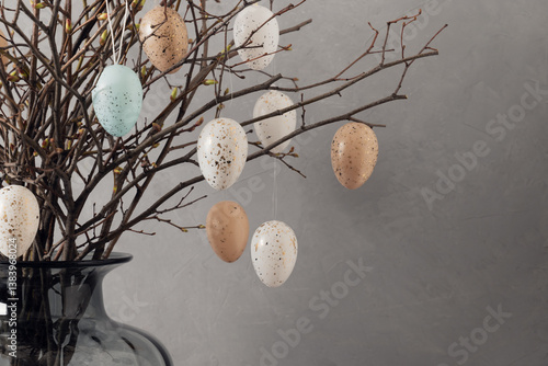 Obraz na płótnie Easter tree decorated colorful pastel white and beige eggs. Birch branches with hang eggs in dark vase on gray background. Happy Easter greeting card. Close up w salonie