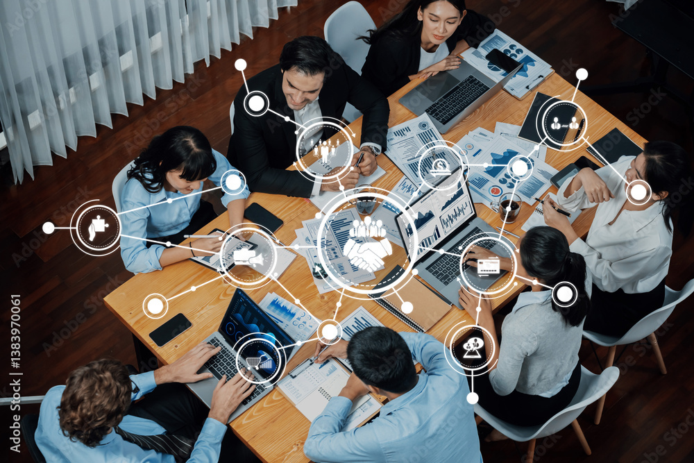 A dynamic business meeting in a modern office setting, showcasing a diverse group of professionals engaged in data analysis and strategy development with laptops and charts. Amity