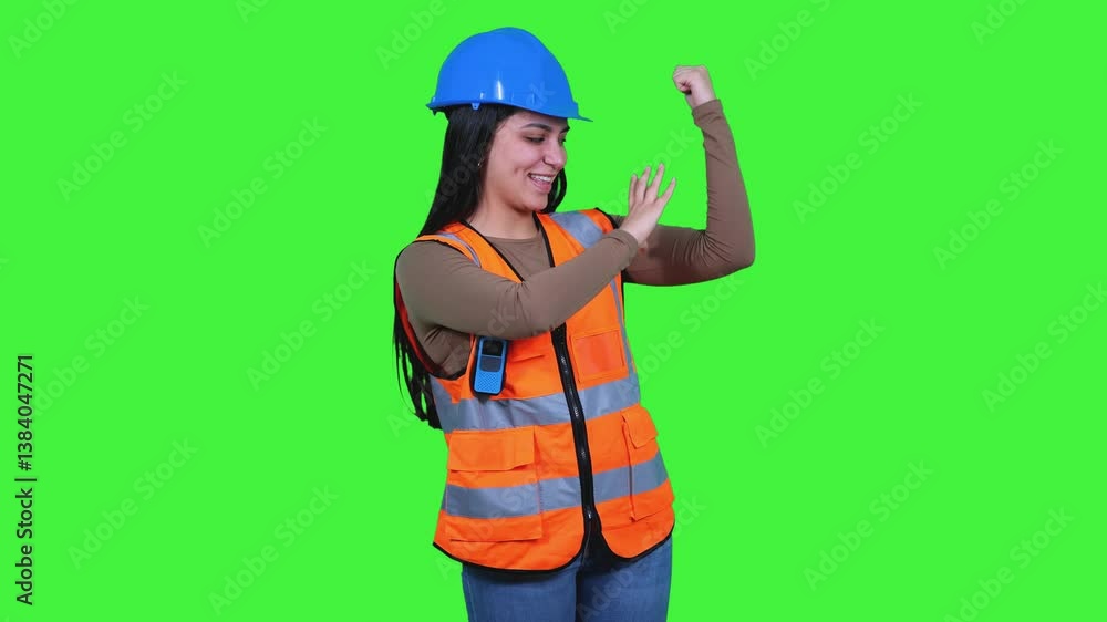 Young Latin woman engineer wearing safety helmet and vest, pointing with finger, flexing biceps Young Latin woman engineer wearing safety helmet and vest, pointing with finger, flexing biceps