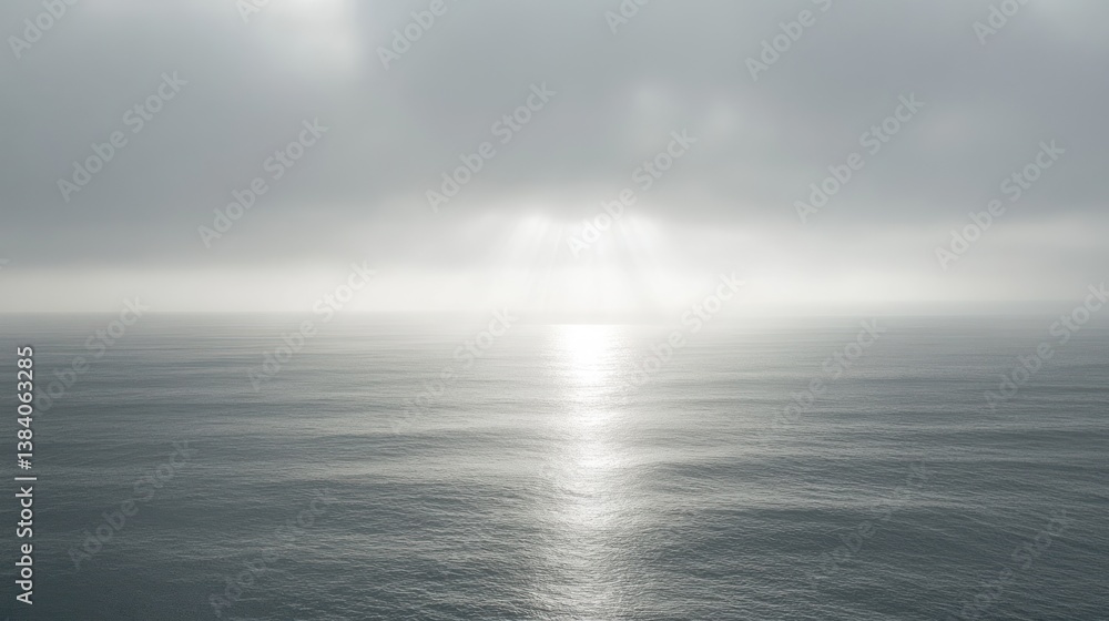 Sun rays breaking through overcast sky over calm ocean. Sun rays breaking through overcast sky over calm ocean.
