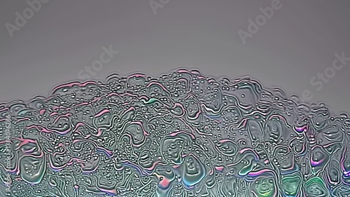 Colorful soap bubble patterns on a gray background  