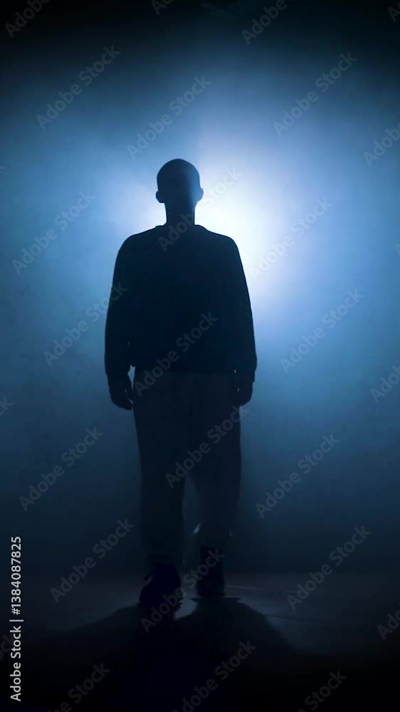 silhouette of a man posing in dark space with bright backlight. High quality 4k footage silhouette of a man posing in dark space with bright backlight. High quality 4k footage