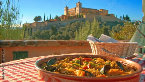 Paella dish on checkered table with alhambra palace in the background in granada spain andalusian food iberia