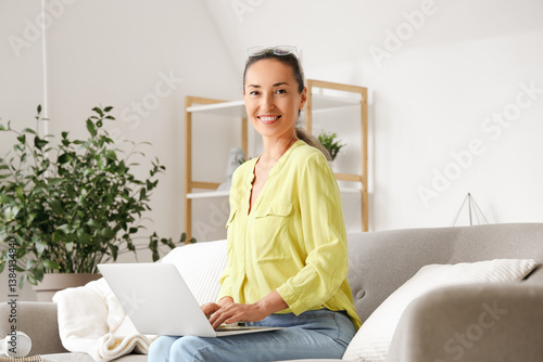 Mature woman with laptop si...