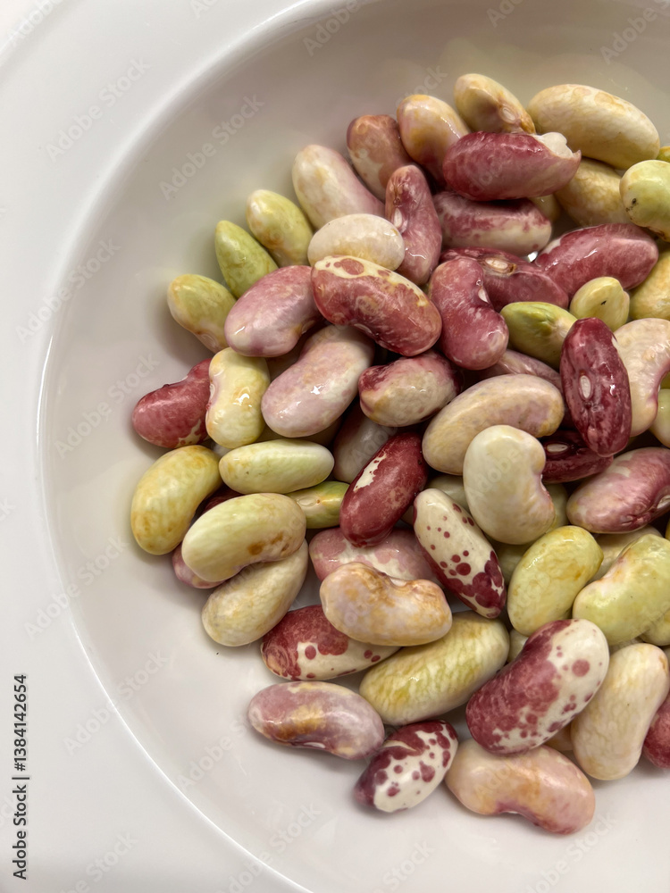 Fototapeta premium A beautiful variety of colorful, dried beans beautifully displayed in a bowl for cooking