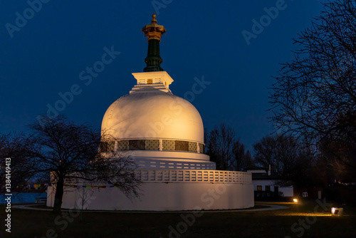 Canvas Print Peace pagoda buddhist temple shire in Vienna on the bank of Donau river during the day and night