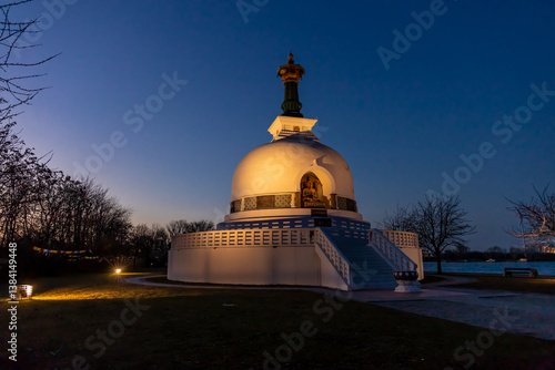 Photography Peace pagoda buddhist temple shire in Vienna on the bank of Donau river during the day and night