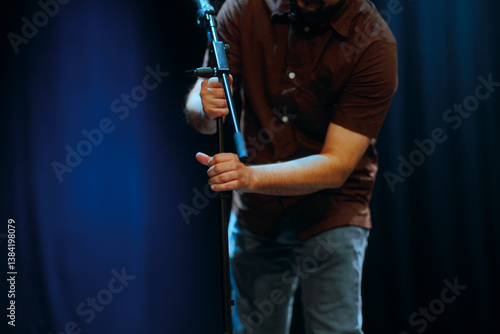 Fotografie Technician Adjusts and Arranges a Microphone on Stage