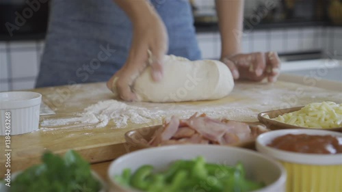 A woman is preparing dough for baking bread.