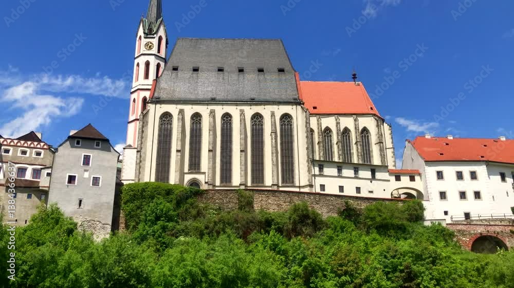 Cathedral on a hill with surrounding buildings, trees and river. European town on a summers day. Cesky Krumlov, Czech Republic. Europe. Cathedral on a hill with surrounding buildings, trees and river. European town on a summers day. Cesky Krumlov, Czech Republic. Europe.