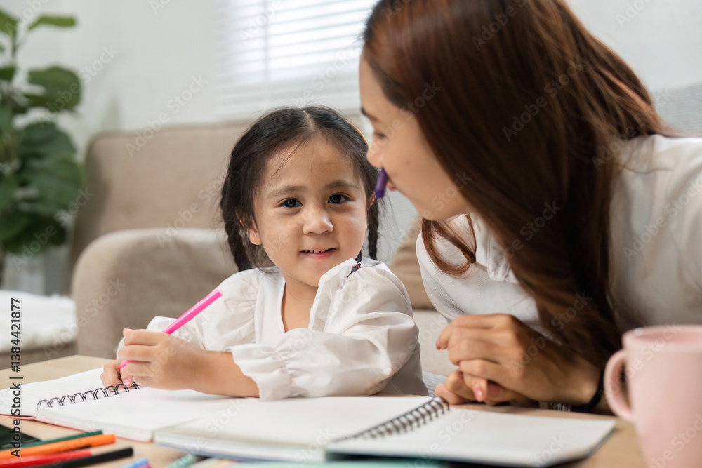 Encouraging Growth and Study Time. A mother and daughter share a close study session filled with support and creativity. Encouraging Growth and Study Time. A mother and daughter share a close study session filled with support and creativity.
