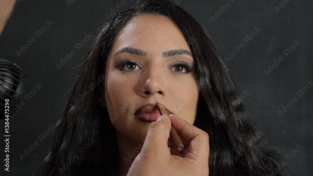 A comprehensive beauty makeup application for a model in a professional studio setting A comprehensive beauty makeup application for a model in a professional studio setting