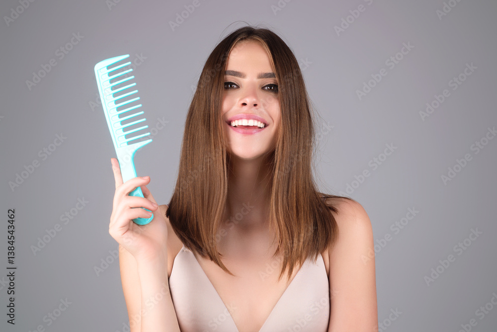 Young woman combing hair. Beautiful woman brush healthy hairs. Hairstyle and haircare concept. Girl combing and brushing hair in studio. Woman with comb combing hair. Hair brush.