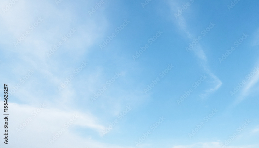 Wide-angle view of a bright blue sky with thin, wispy white clouds. Premium bright daytime sky background for posters and banners. Wide-angle view of a bright blue sky with thin, wispy white clouds. Premium bright daytime sky background for posters and banners.