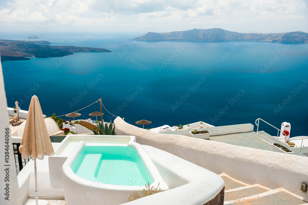 Fototapeta premium White architecture in Santorini island, Greece. Swimming pool with sea view.