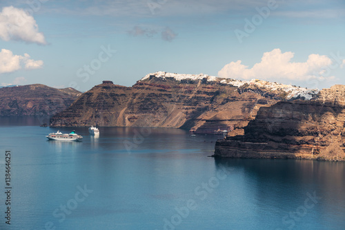 Santorini island, Greece. Blue sea and the blue sky with clouds. Cruise ship near the coast