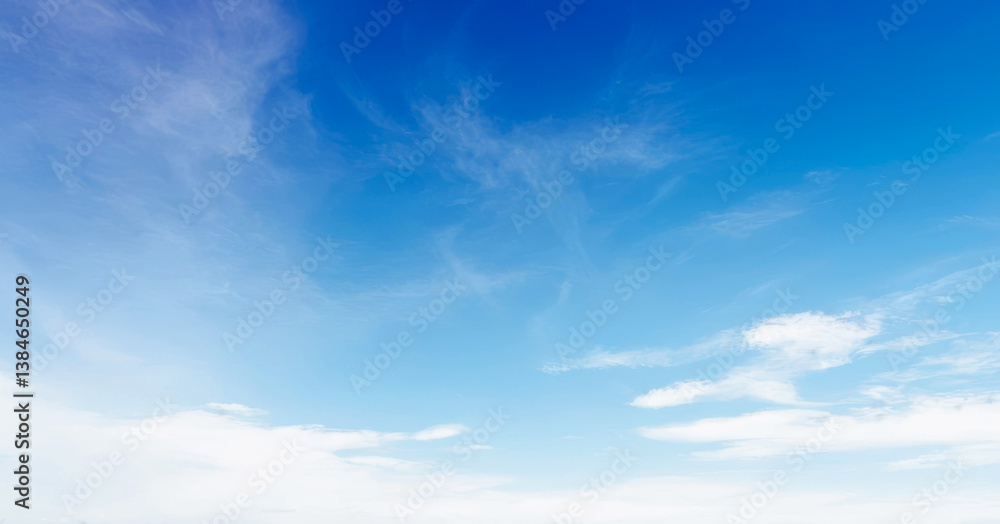 Obraz premium Clear blue sky with wispy clouds on a sunny day. Clean photo of blue sky during the day, Premium background for banner and wallpaper.