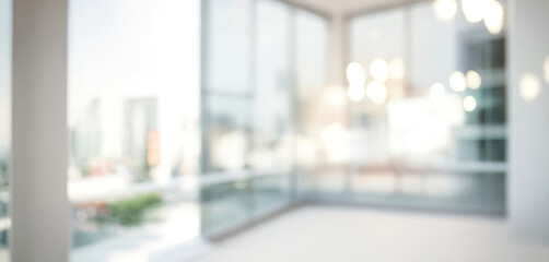 Bright and spacious office space in an unfocused view. Modern blurred background photo for banner, poster or magazine and website background.