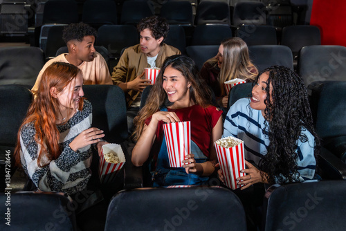 Obraz na plátně Young people enjoying movie and popcorn at cinema