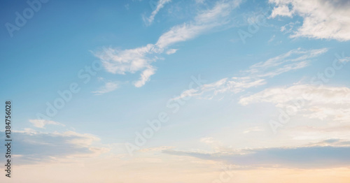 Fototapeta Naklejka Na Ścianę i Meble -  Breathtaking view of a pale blue sky with wispy white clouds at sunset. Background photos for banners, posters and wallpapers.