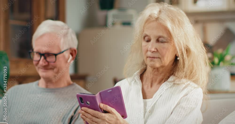 Portrait of charming grey-haired woman with smartphone, using mobile application . Modern internet technology for distant communication and online shopping, lady ordering goods in web store from home Portrait of charming grey-haired woman with smartphone, using mobile application . Modern internet technology for distant communication and online shopping, lady ordering goods in web store from home