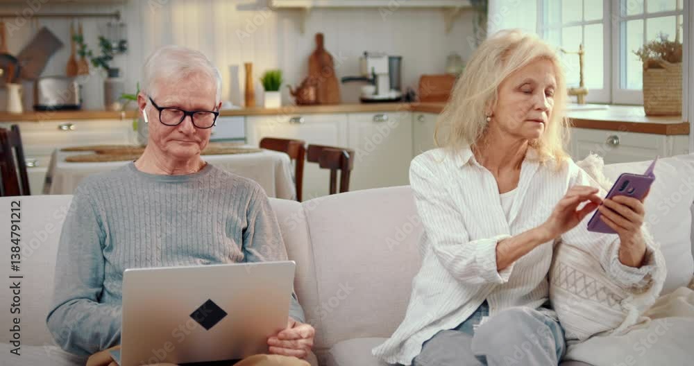 Internet addiction and modern technology, elderly people with mobile gadgets. Portrait of aged man with laptop and old woman with smartphone, grandmother and grandfather at home, leisure in weekend Internet addiction and modern technology, elderly people with mobile gadgets. Portrait of aged man with laptop and old woman with smartphone, grandmother and grandfather at home, leisure in weekend