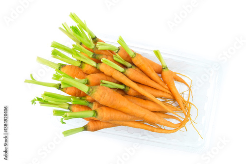 carrots on a white background, Top view of fresh baby carrots in clear plastic container isolated on white background flat lay stack