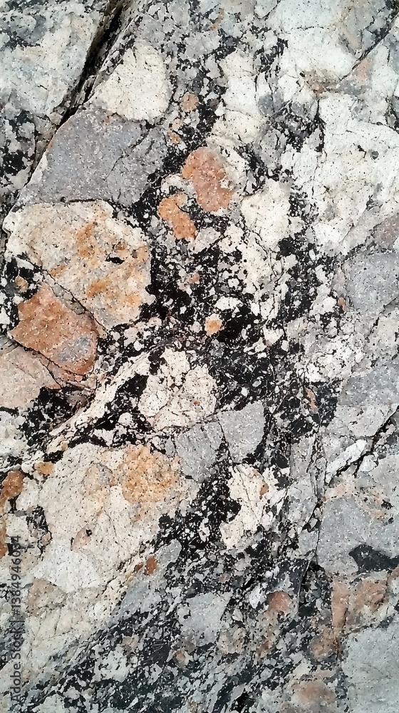 Fototapeta premium Closeup of rough granite texture with black white and gray speckles