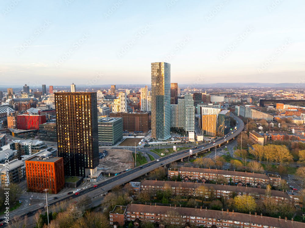 Obraz premium Aerial image of Mancunian Way at Hulme, Manchester with the city skyline at Sunset. 